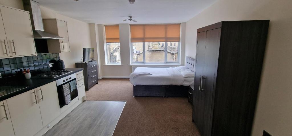 a small kitchen with a bed and a window at PENTHOUSE APARTMENT IN CENTRAL HALIFAX in Halifax