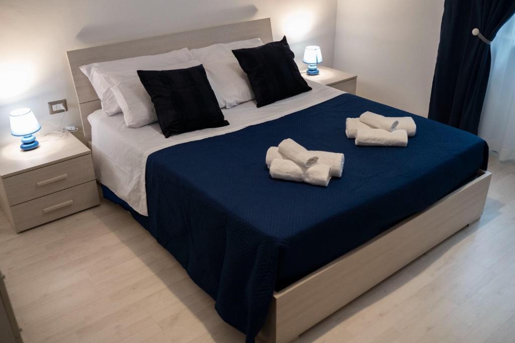 a bedroom with a large bed with towels on it at B&BSCICCHERI in Castellammare di Stabia