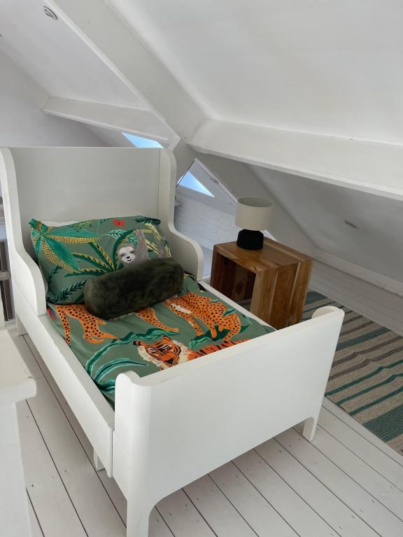 a white chair with a pillow on it in a room at Harcombe Barn near Bristol in Bristol