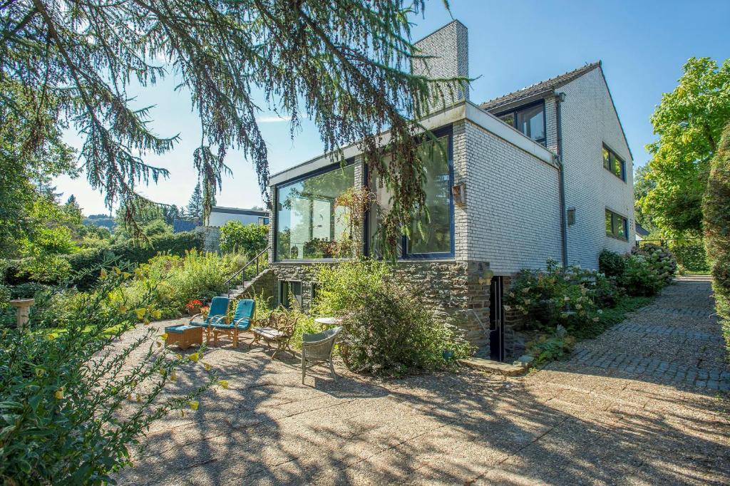 a house with glass windows and a patio at B&B Nouveauté in Vaals