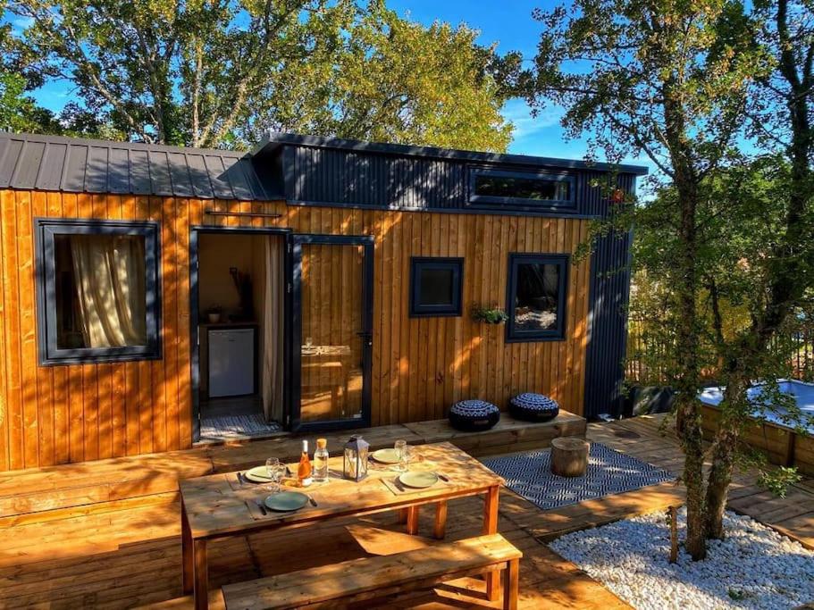 a wooden cabin with a table in front of it at Tiny LiLouMaCa Cœur Ste Baume in Plan dʼAups