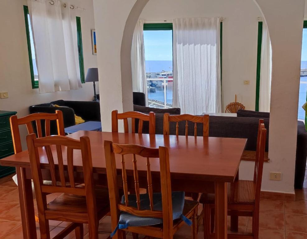 a dining room with a wooden table and chairs at Casa Puerto de la Estaca in Puerto de la Estaca