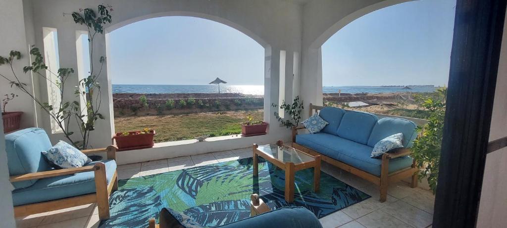 a living room with a view of the ocean at Sea Pearl in Ras Sedr