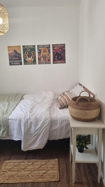 a bedroom with a bed and a table and posters at Luxury peaceful, free parking in Rechovot