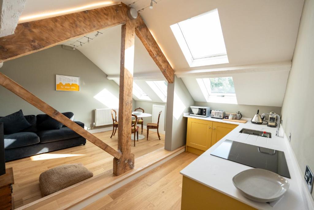 a kitchen and living room with a loft at Glyder - Snowdonia, North Wales in Bethesda