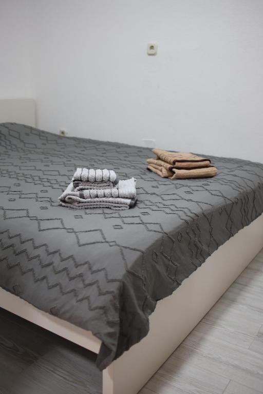 a bed with two towels on top of it at Cavleski apartment in Prilep