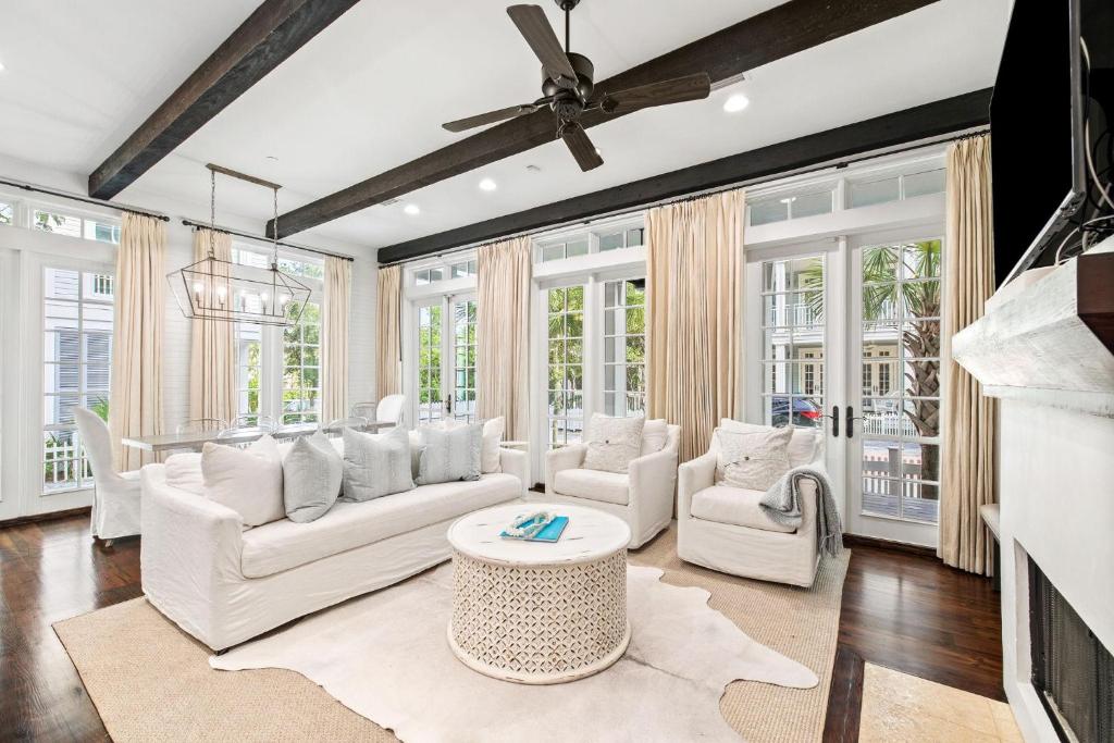 a living room with white furniture and windows at Our Happy Place in Santa Rosa Beach