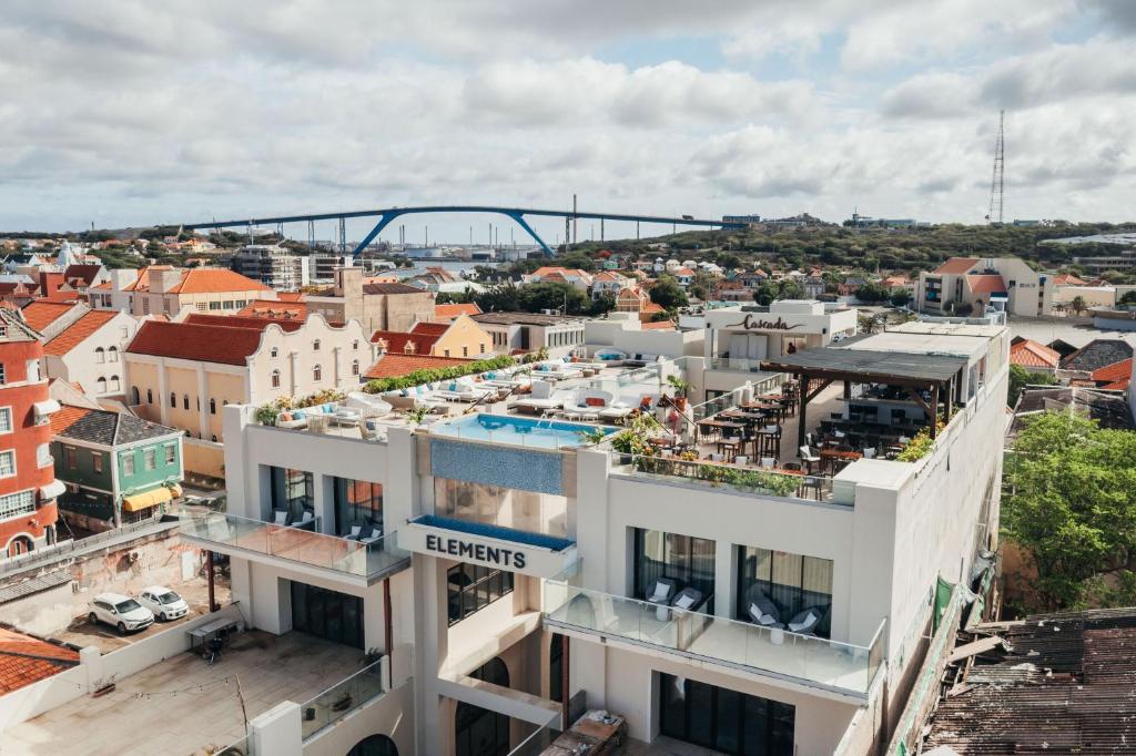 an apartment building with a view of a city at Elements Hotel & Shops Curaçao in Willemstad