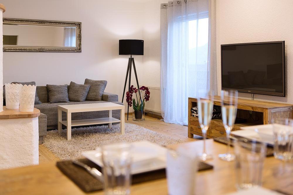 a living room with a couch and a flat screen tv at Apartment Schafbergblick mit Balkon ID 8607747 und Apartment Himmelspforte mit Balkon ID 8607779 in Mondsee