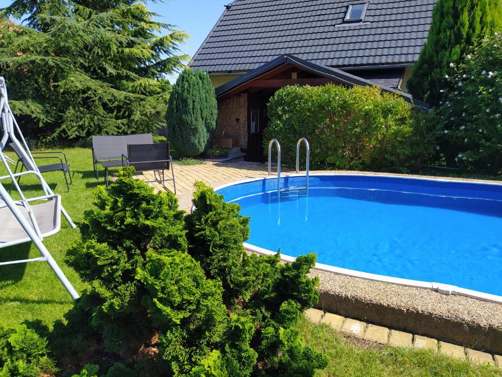 a swimming pool in the yard of a house at Vila Callum RELAX & WELLNESS in Ostrava
