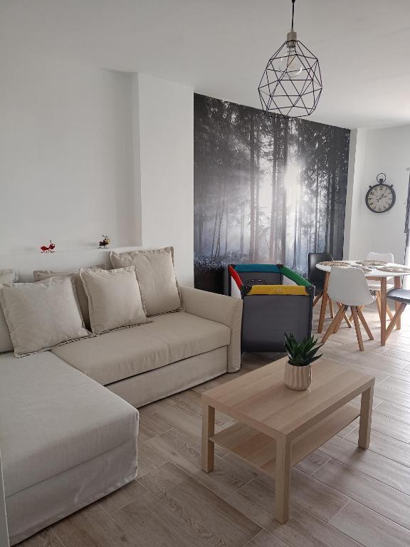 a living room with a couch and a table at La Lunita in Valverde