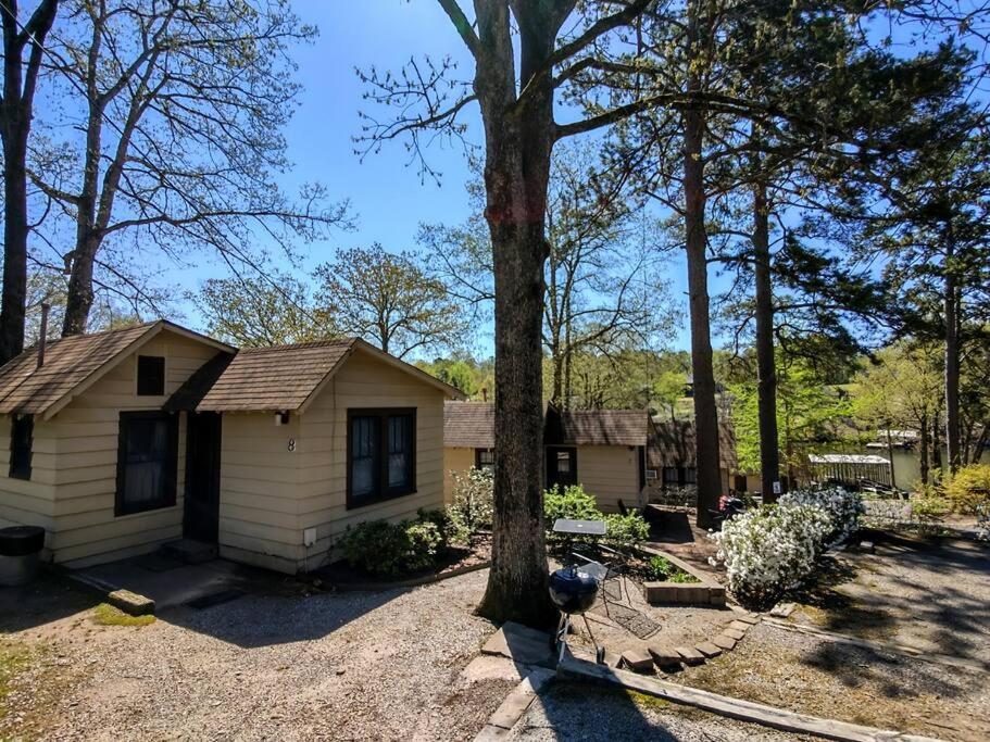 a small house with a tree in front of it at #08 - One Bedroom Lakeview Cottage-Pet Friendly in Hot Springs