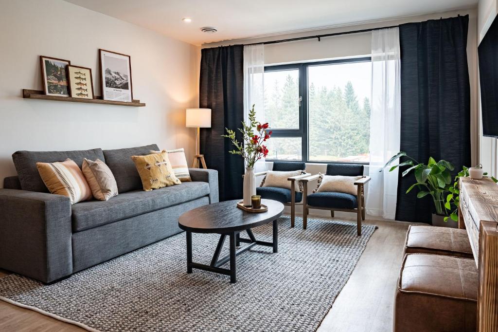 a living room with a couch and a table at The Selkirk House by Revelstoke Vacations in Revelstoke