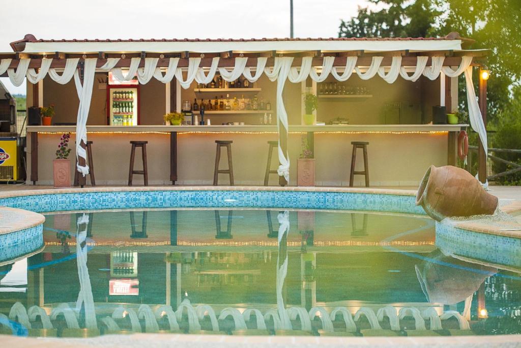 a pool at a resort with a bar at Sunny Hill in Sani Beach