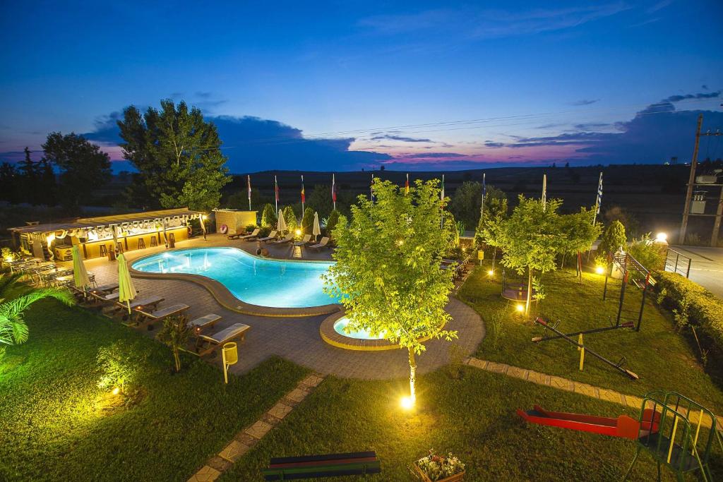 an overhead view of a swimming pool at night at Sunny Hill in Sani Beach