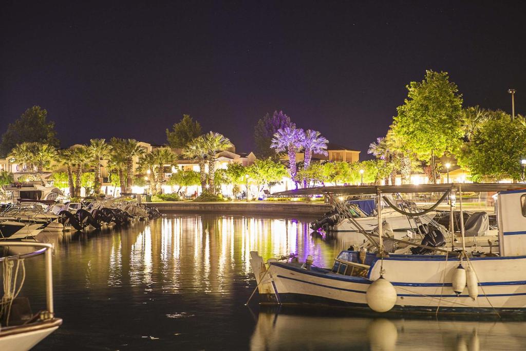 a group of boats docked in a marina at night at Sunny Hill in Sani Beach