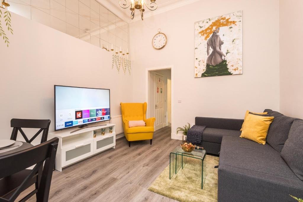 uma sala de estar com um sofá e uma televisão em 1Bed, Ground floor, Private Entrance em Edinburgo