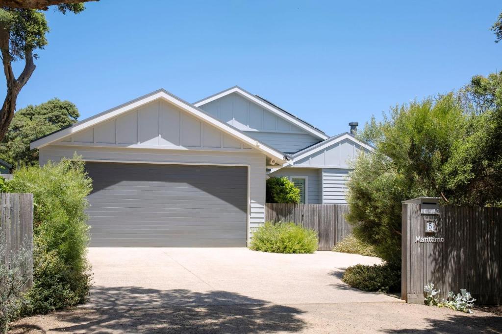 a white house with a garage at Marittimo in Point Lonsdale