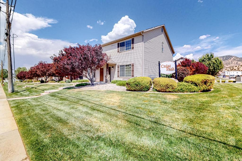 a house with a green lawn in front of it at Cedar Park Oasis in Cedar City