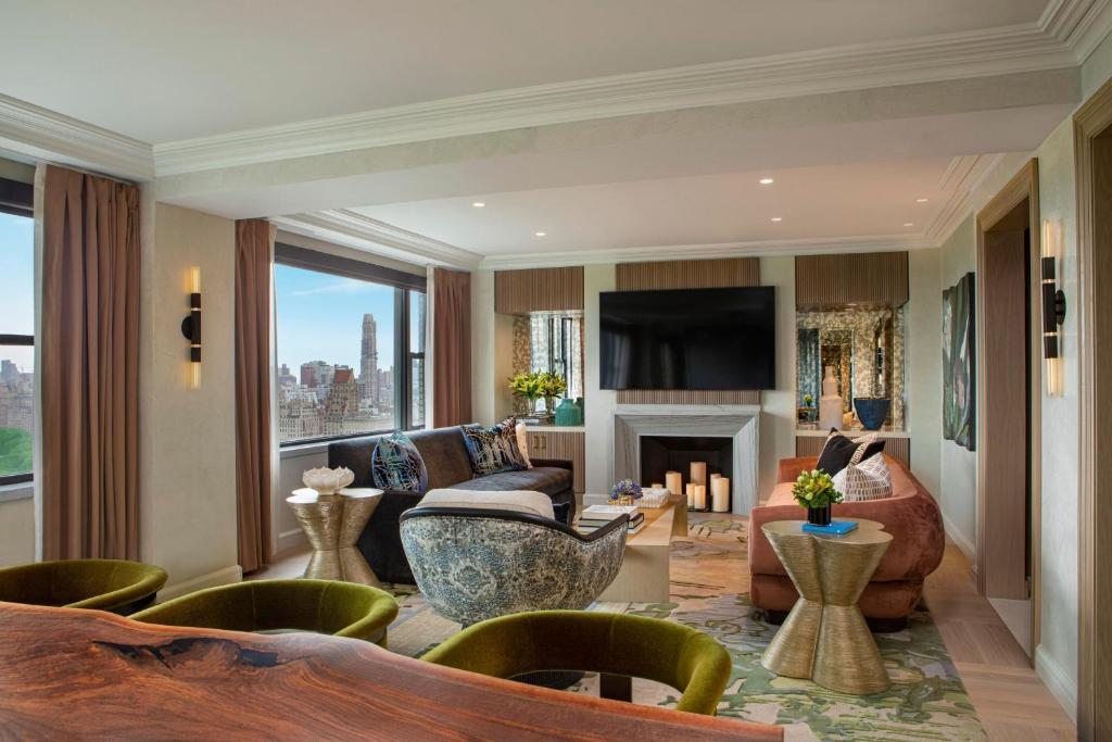 a living room filled with furniture and a fireplace at JW Marriott Essex House New York in New York