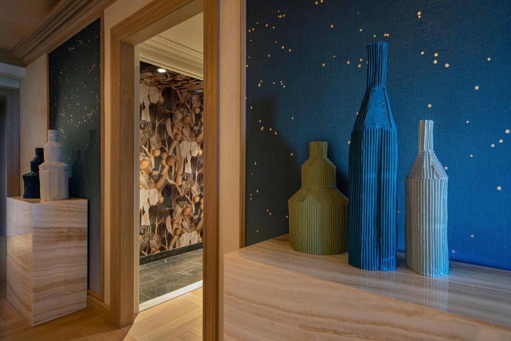 three blue vases sitting on a shelf in a room at JW Marriott Essex House New York in New York