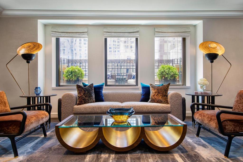 a living room with a couch and a table at JW Marriott Essex House New York in New York