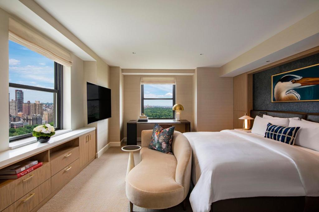 a hotel room with a large bed and a window at JW Marriott Essex House New York in New York