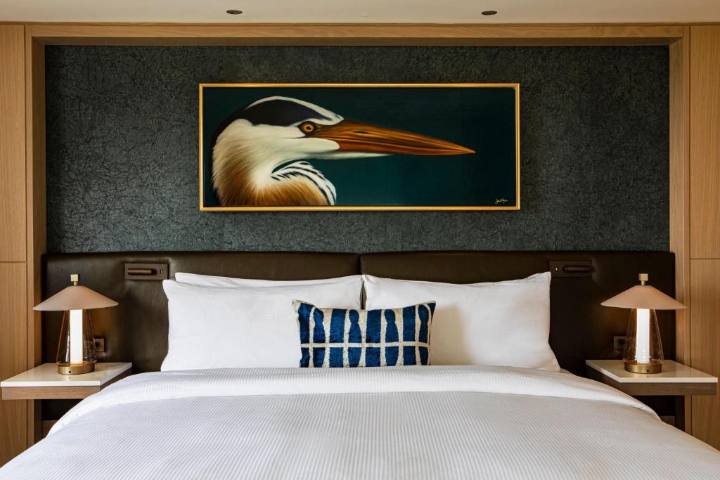 a painting of a bird on the head of a bed at JW Marriott Essex House New York in New York