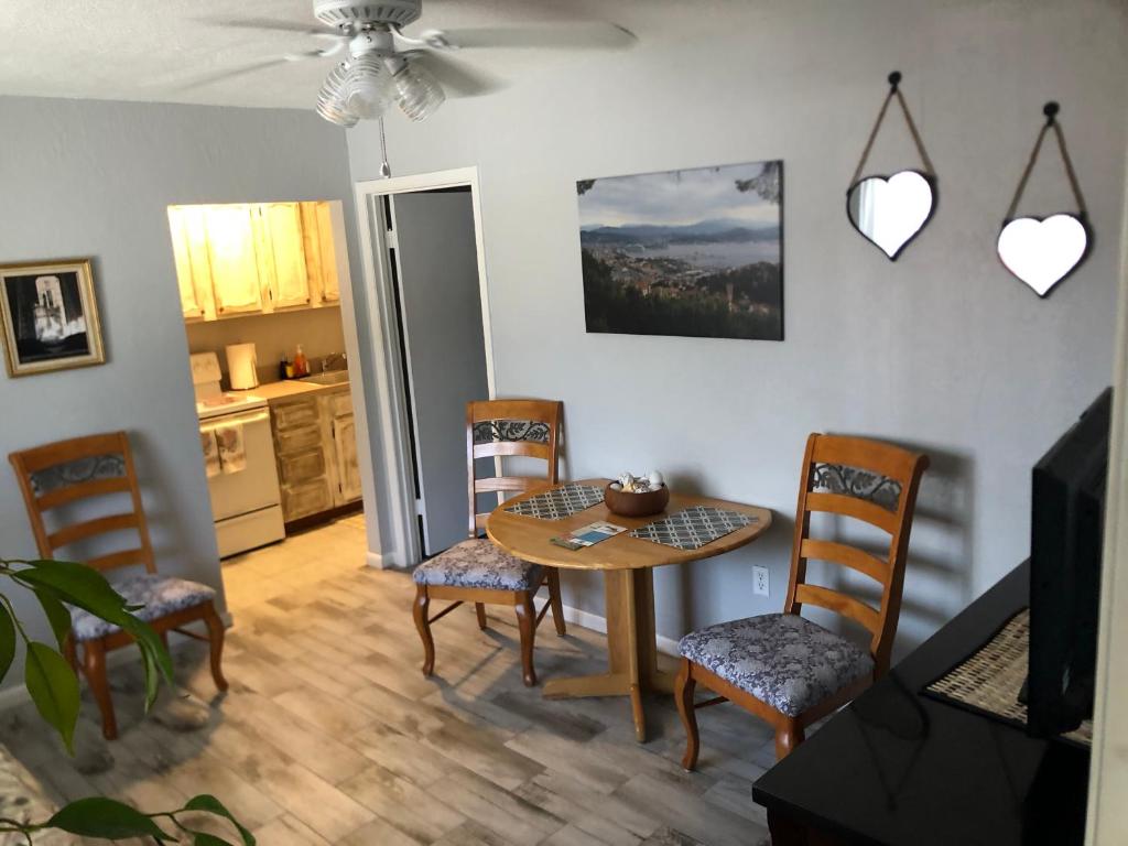 a kitchen and dining room with a table and chairs at Surfside Suites in Cocoa Beach