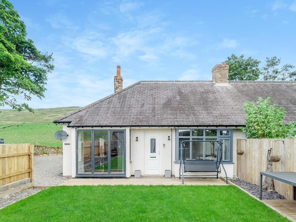 a cottage with a garden in front of it at Vallum Villa - Uk40231 in Bardon Mill