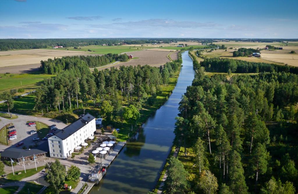 an aerial view of a river next to a building at Norrqvarn Hotell in Lyrestad