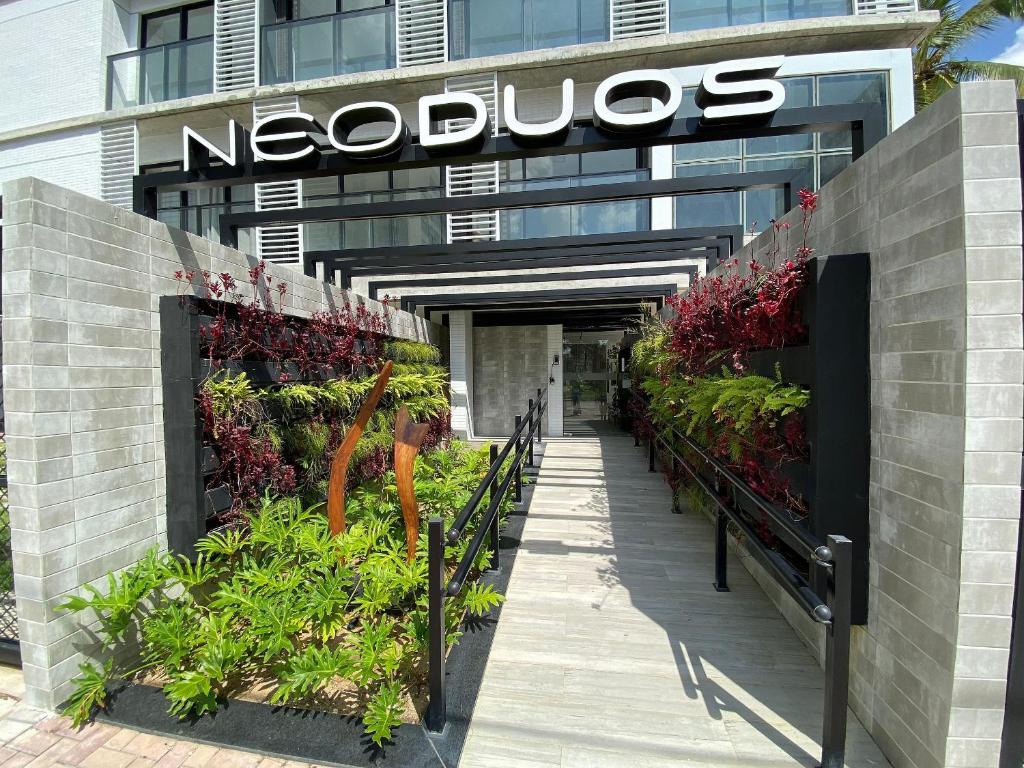 a nocios sign on the side of a building with plants at Bela Hospedagem - #Neo Duos 104 in Cabedelo
