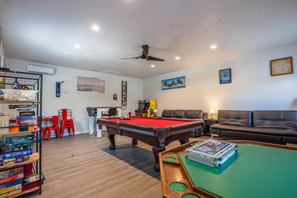 a living room with a pool table and a couch at Blue Oasis minutes from the beach with Gameroom! in Corpus Christi