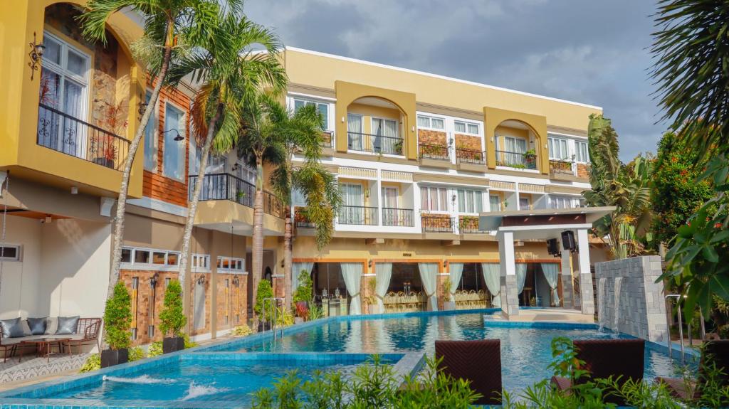 ein Hotel mit einem Pool vor einem Gebäude in der Unterkunft Ragazzi Resort Hotel in Naga