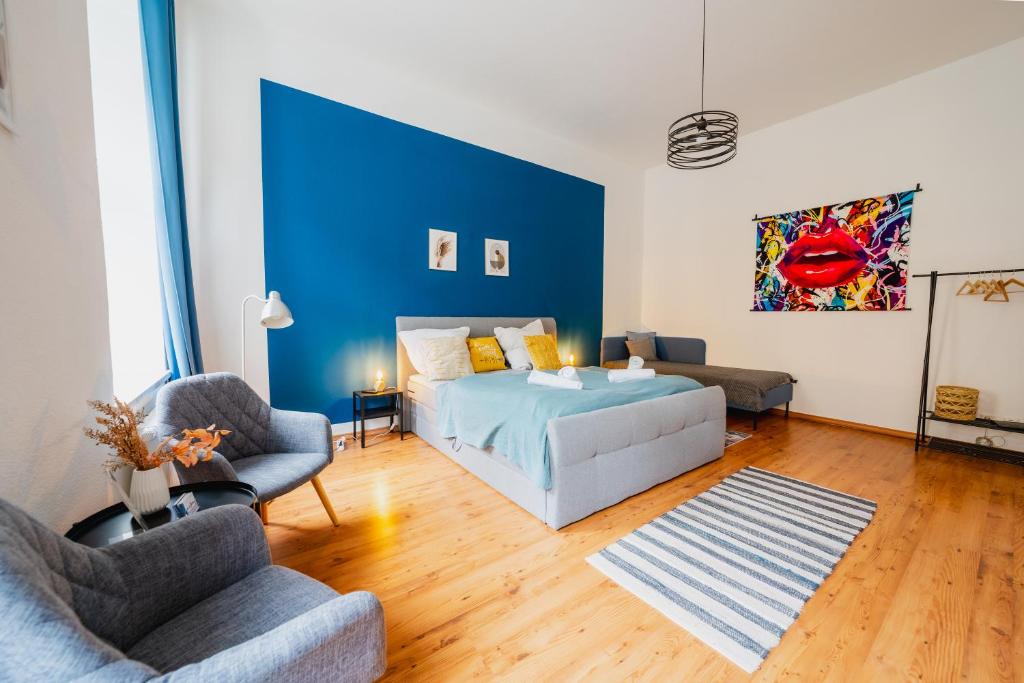 a bedroom with a bed and a blue wall at Blue Chili 02 - MD Zentral City Carré Wlan Netflix in Magdeburg