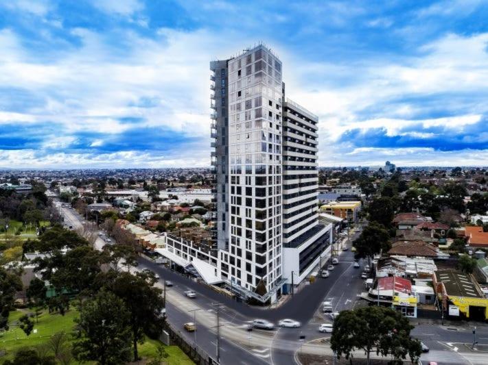 a tall white building in a city with a street at 1 BEDROOM STUNNING VIEW APARTMENT in Melbourne
