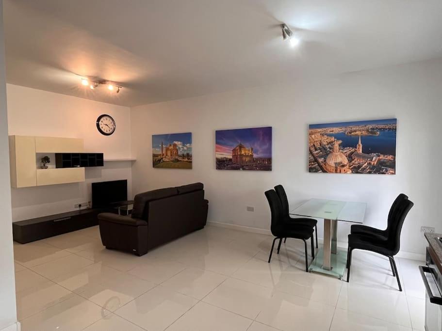 ein Wohnzimmer mit einem Sofa und einem Tisch in der Unterkunft Cosy 2Bedroom 1 min walk away from the sea apartment 1 in Gżira