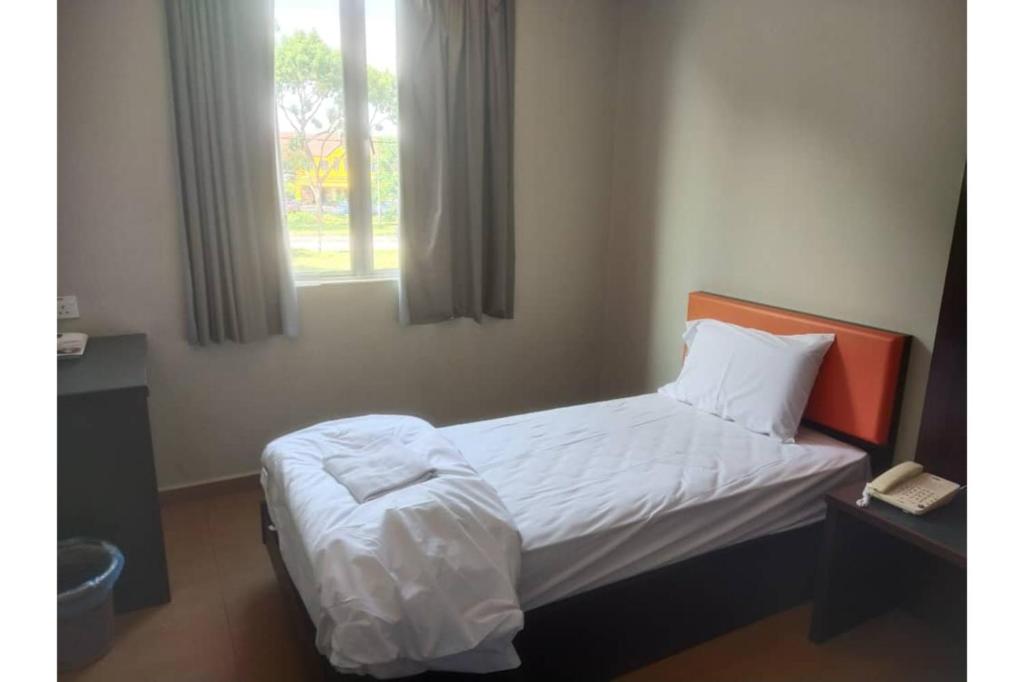 Postel nebo postele na pokoji v ubytování JQ Suria Hotel
