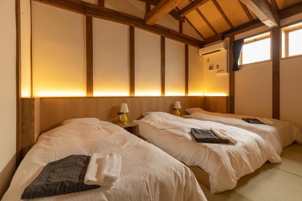 Postel nebo postele na pokoji v ubytování Classic ＆ modern SELF-STYLED HOTEL 番場おおそね