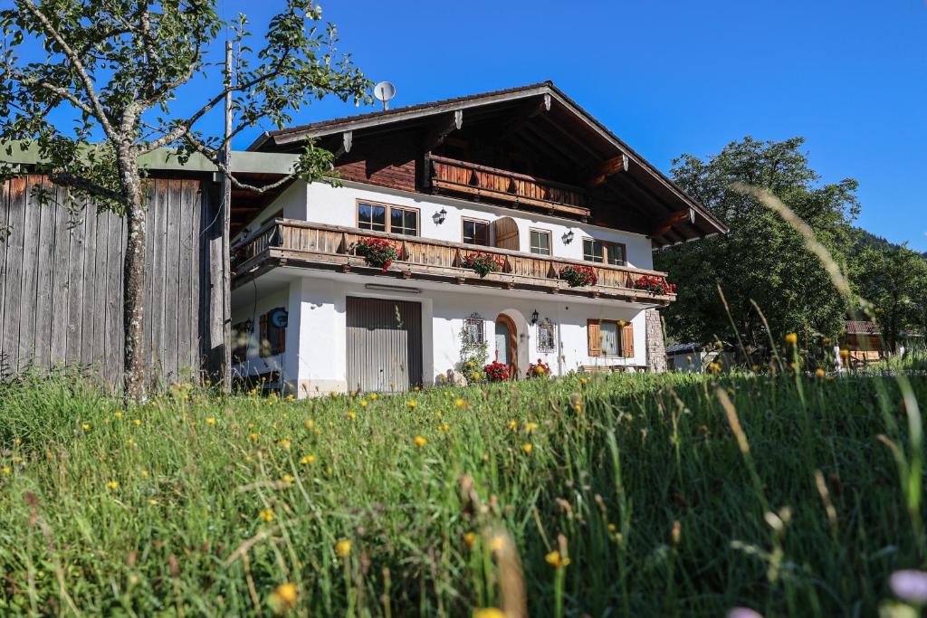 a house on a hill with a field of flowers at Maurerlehen in Berchtesgaden