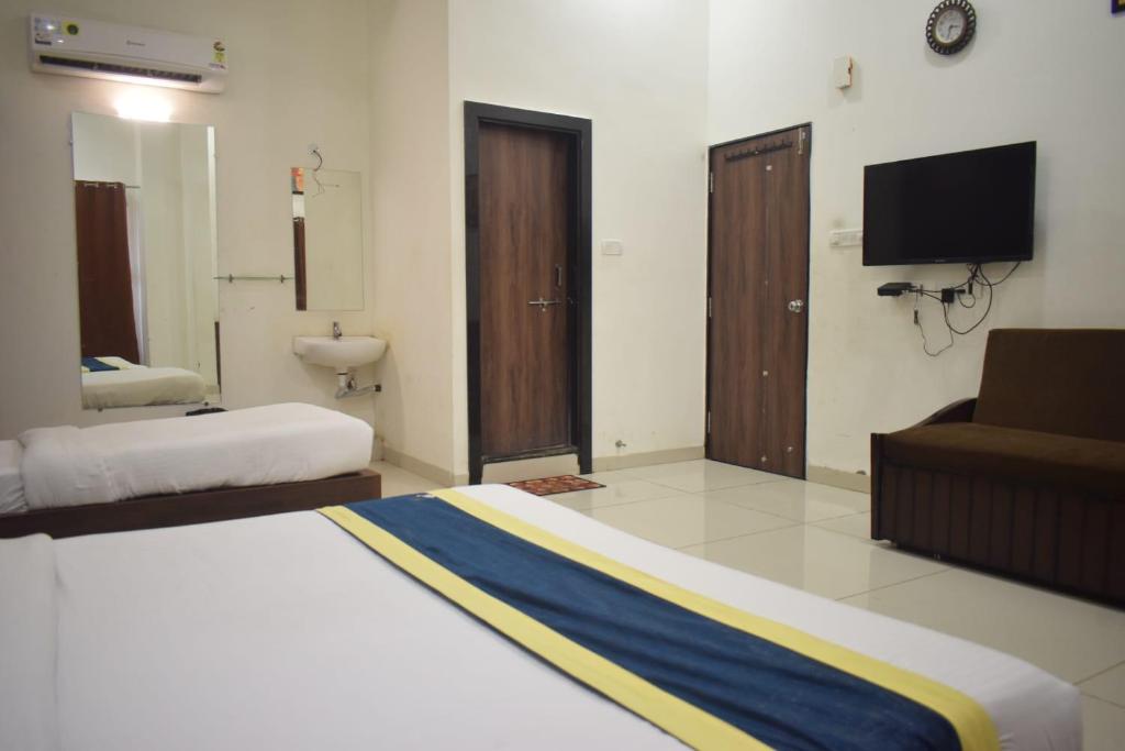 Postel nebo postele na pokoji v ubytování Hotel Lakshya Sheesh Mahal Indore