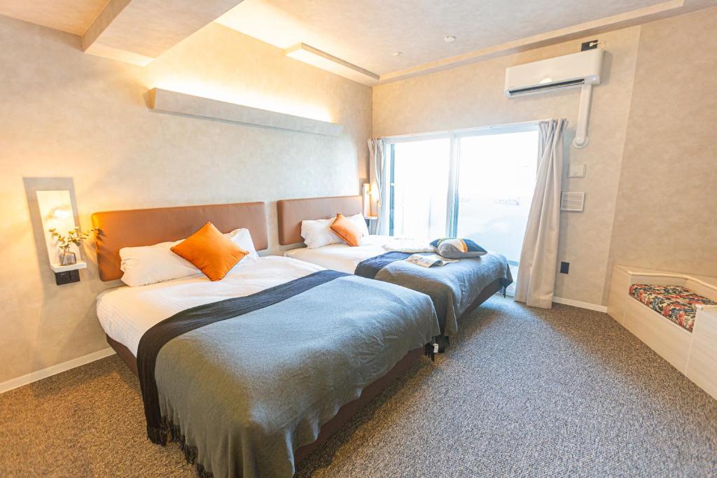 Ένα ή περισσότερα κρεβάτια σε δωμάτιο στο Apartment Hotel 11 Umeda