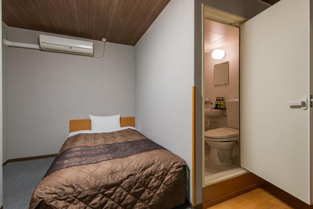 Postel nebo postele na pokoji v ubytování Hotel Wakamatsu Excel