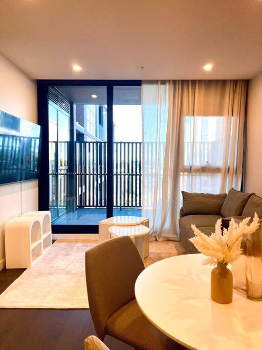 a living room with a couch and a table at Anthem Stylish 1BR Apartment - with top amenities and easy airport access in Melbourne
