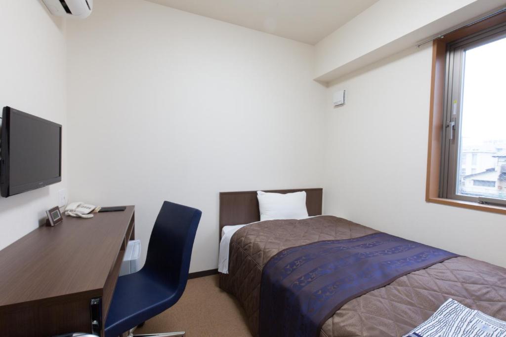 Postel nebo postele na pokoji v ubytování Hotel Wakamatsu Excel