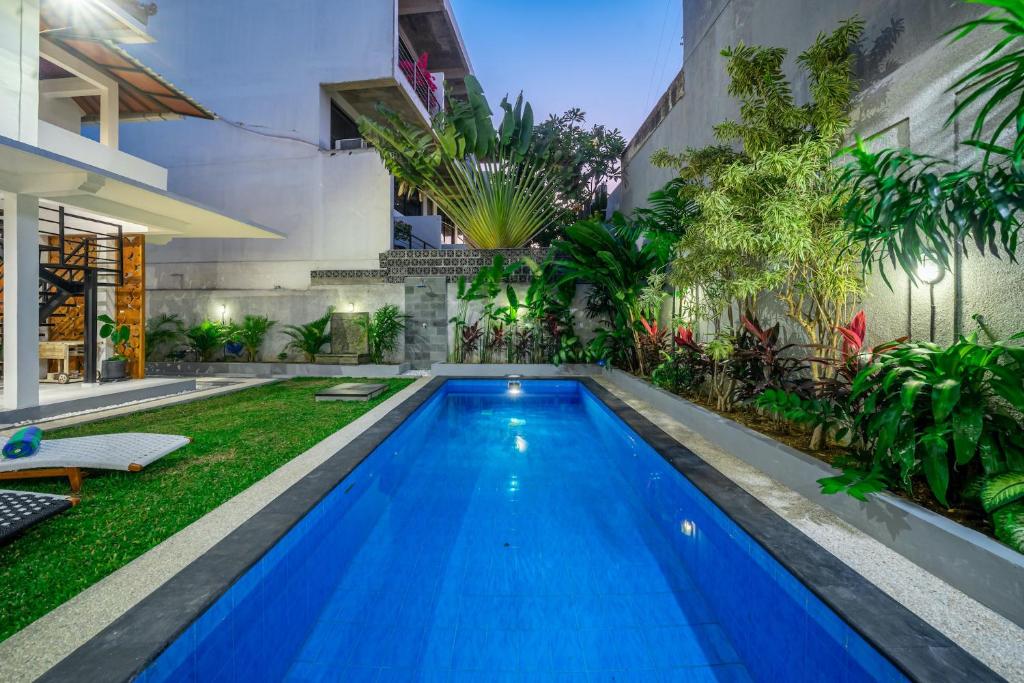 a swimming pool in the backyard of a house at Villa Lebah - Tranquil Paradise of 3 bedroom Heart of Seminyak in Seminyak