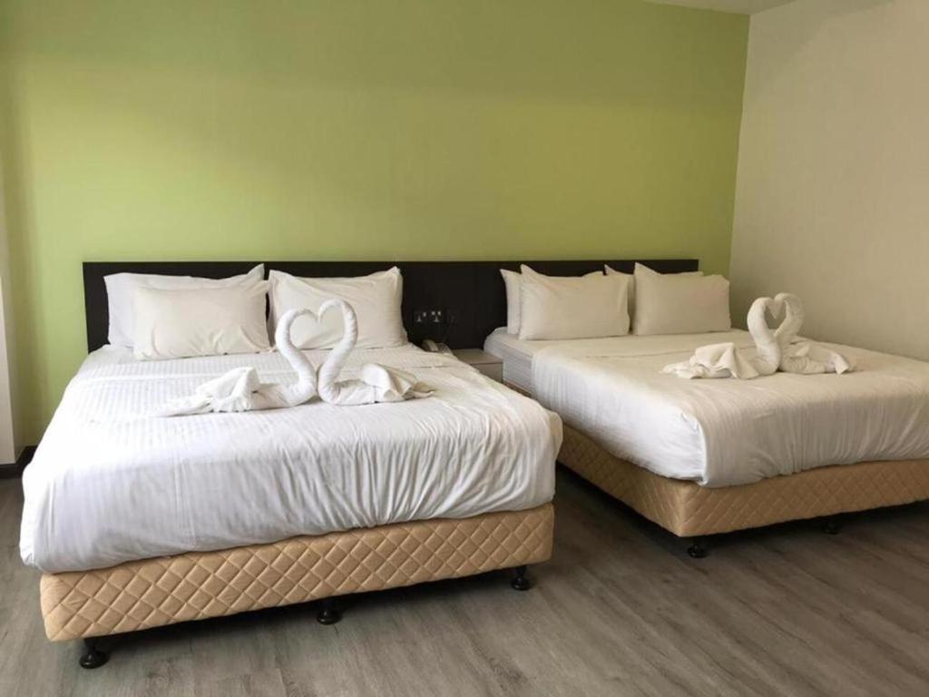 Postel nebo postele na pokoji v ubytování TT Dorf Hotel Matang