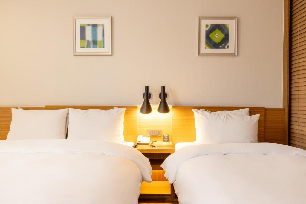Postel nebo postele na pokoji v ubytování Mate Hotel Paju