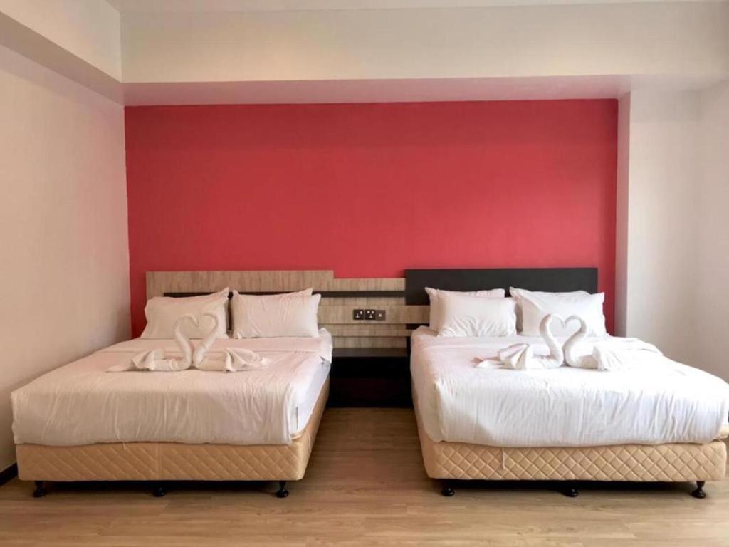 Postel nebo postele na pokoji v ubytování TT Dorf Hotel Matang