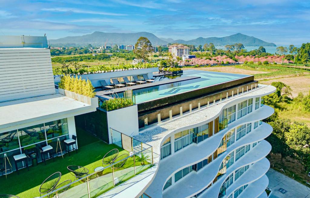 an aerial view of a building with a swimming pool at Mirage Condominium in Sattahip